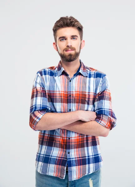 Handsome man standing with arms folded