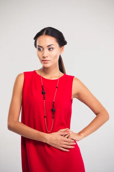 Beautiful woman posing in red dress — Stock Photo, Image