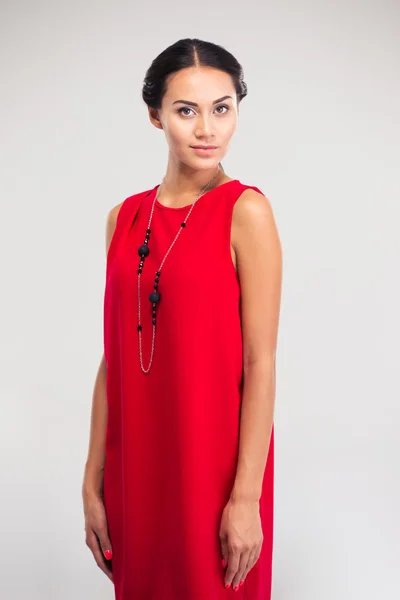 Pretty woman posing in red dress — Stock Photo, Image