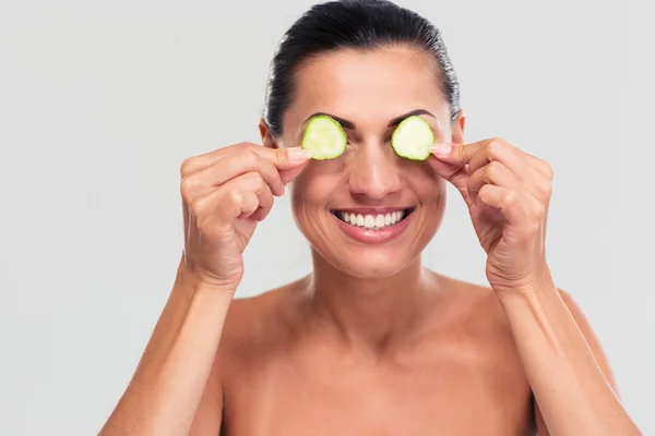 Happy woman covering her eyes with cucumber — Stock Fotó