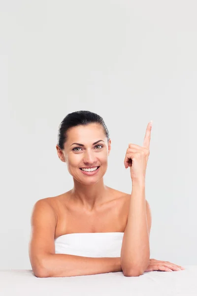 Woman sitting at the table and showing finger up — Stok fotoğraf