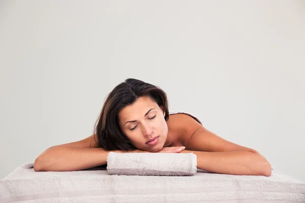 Woman lying on massage lounger in a wellness center — Stock Photo, Image