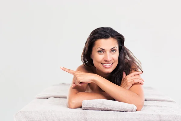 Happy woman lying on massage lounger — Stock Photo, Image