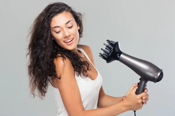 Smiling young woman dries her hai — Stock Photo, Image