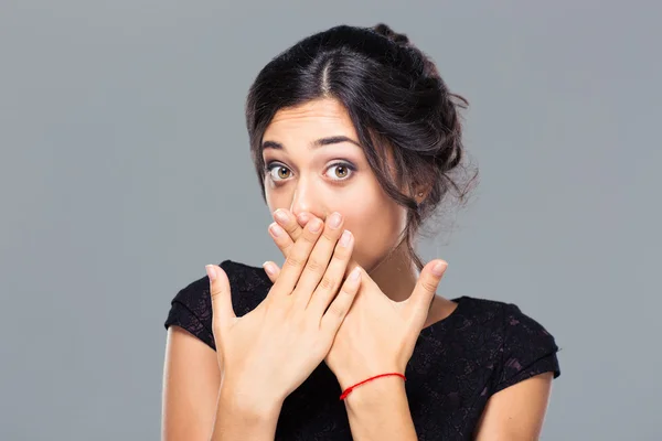 Portrait of a young woman covering her mouth — Stock Photo, Image