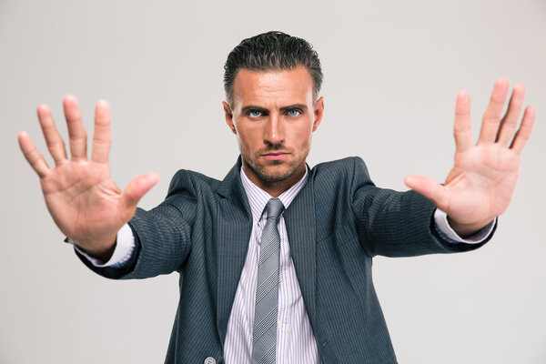 Confident businessman showing stop gesture