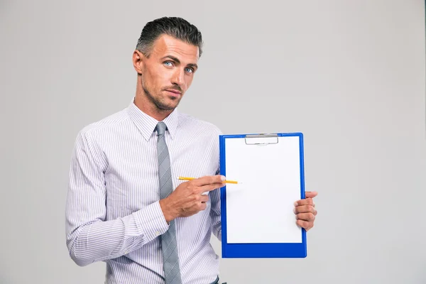 Businessman showing blank clipboard — Stock Photo, Image