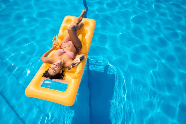 Laughing girl lying on air mattress — Stock Photo, Image