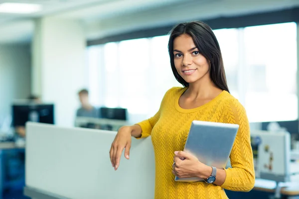 Businesswoman standing with tablet computer in office — Stock Photo, Image