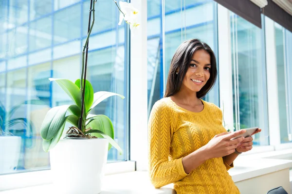 Leende affärskvinna med smartphone — Stockfoto