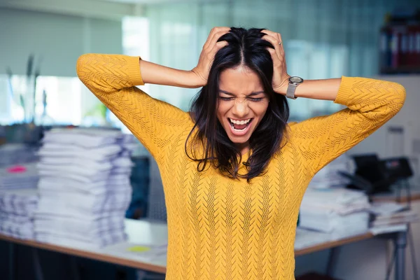 Businesswoman covering her ears and shouting — Stock Photo, Image