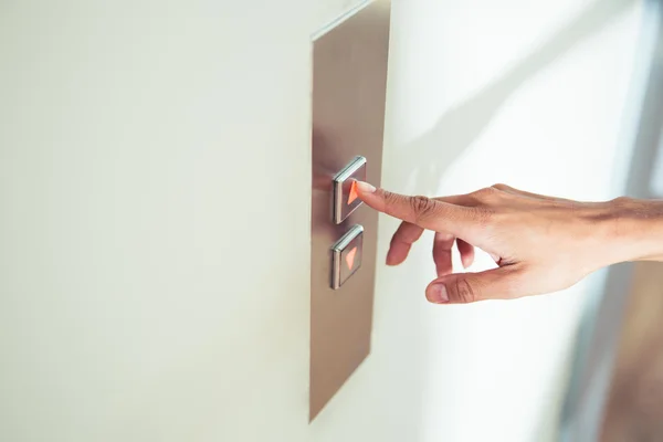 Female finger pushing elevator button — Stock Photo, Image