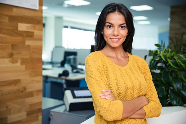 Affärskvinna står med armarna vikta i office — Stockfoto