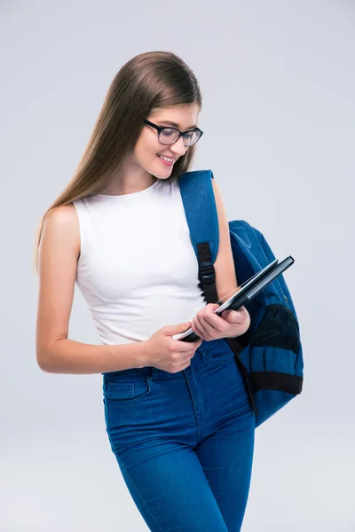 Adolescente femenina con mochila usando tableta —  Fotos de Stock