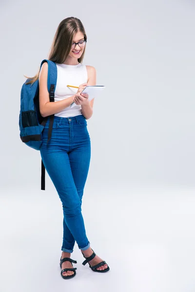 Uśmiechający się nastolatek kobiece pisanie notatki w notesie — Zdjęcie stockowe