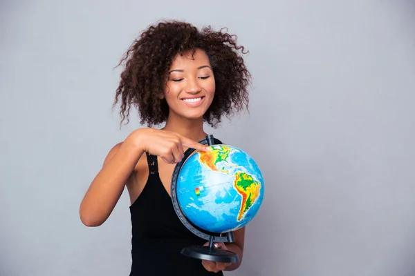 Afro american woman holding globe Stock Photo