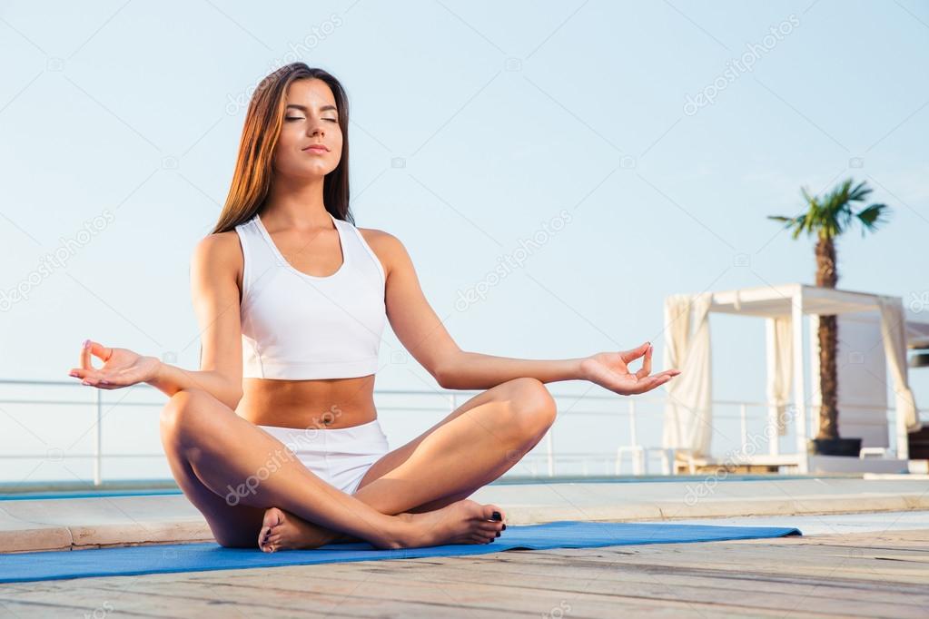 Portrait of a attractive girl meditating 
