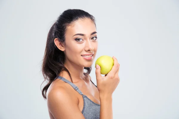 Smiling beautiful woman holding apple — Stock Photo, Image