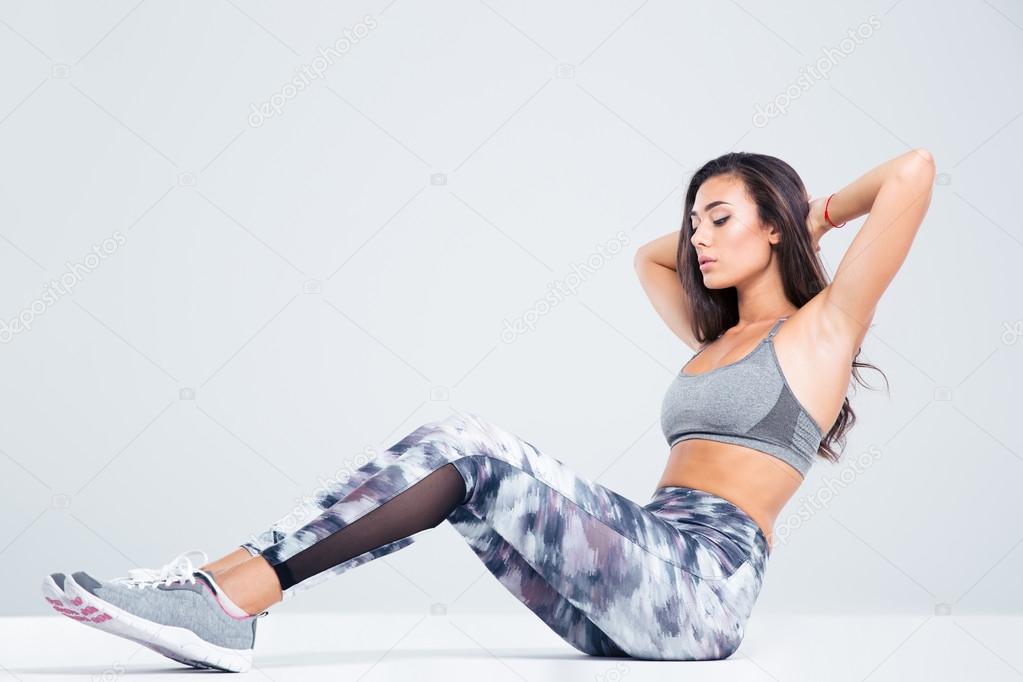 Portrait of a fitness woman doing abs exercises 