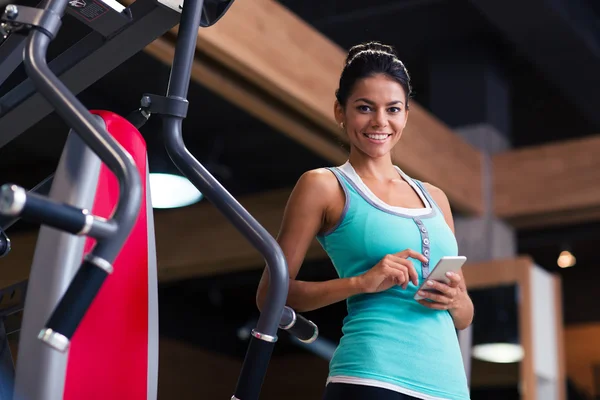 Sport vrouw permanent met smartphone — Stockfoto