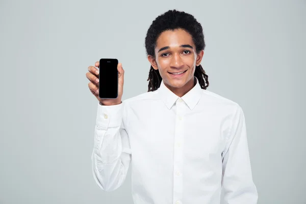 Afro american businessman showing blank smartphone screen — Stock Photo, Image