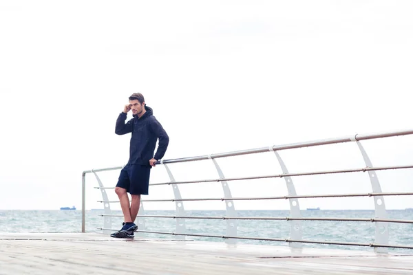 Handsome sports man standing outdoors — Stock Photo, Image