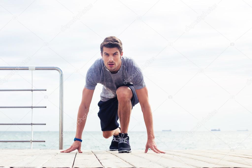 Runner standing in start position outdoors