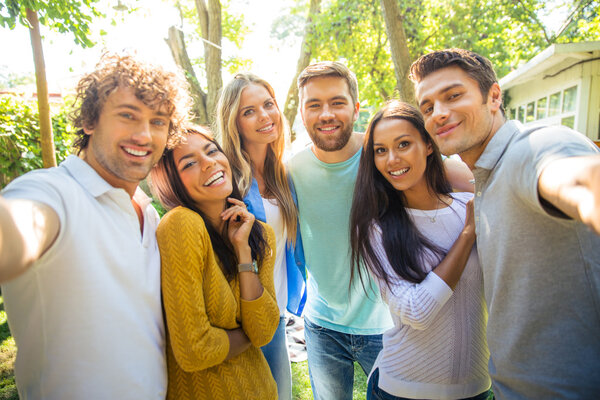 Friends making selfie photo outdoors