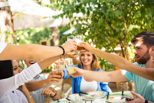 Friends making toast around table — Stock Photo, Image