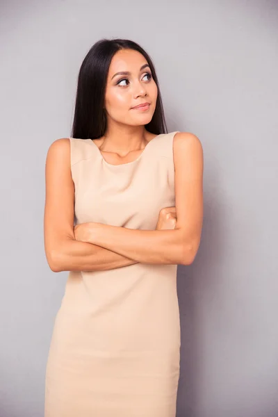 Thoughtful woman standing with arms folded — Stock Photo, Image