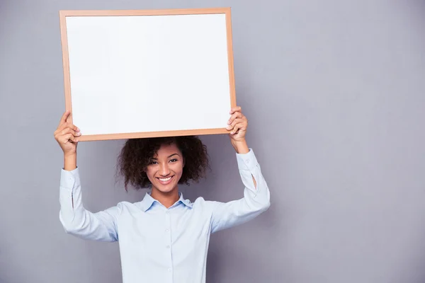 Happy afro american woman holding blank board — Stock Photo, Image