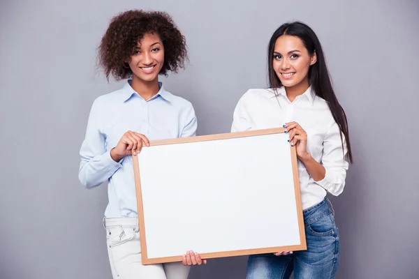 Portrait of a two girls holding blank board — Stock Photo, Image