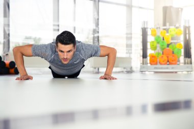 Man doing push-ups at gym  clipart