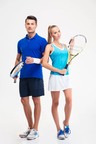 Sports couple standing with tennis racket — Stock Photo, Image