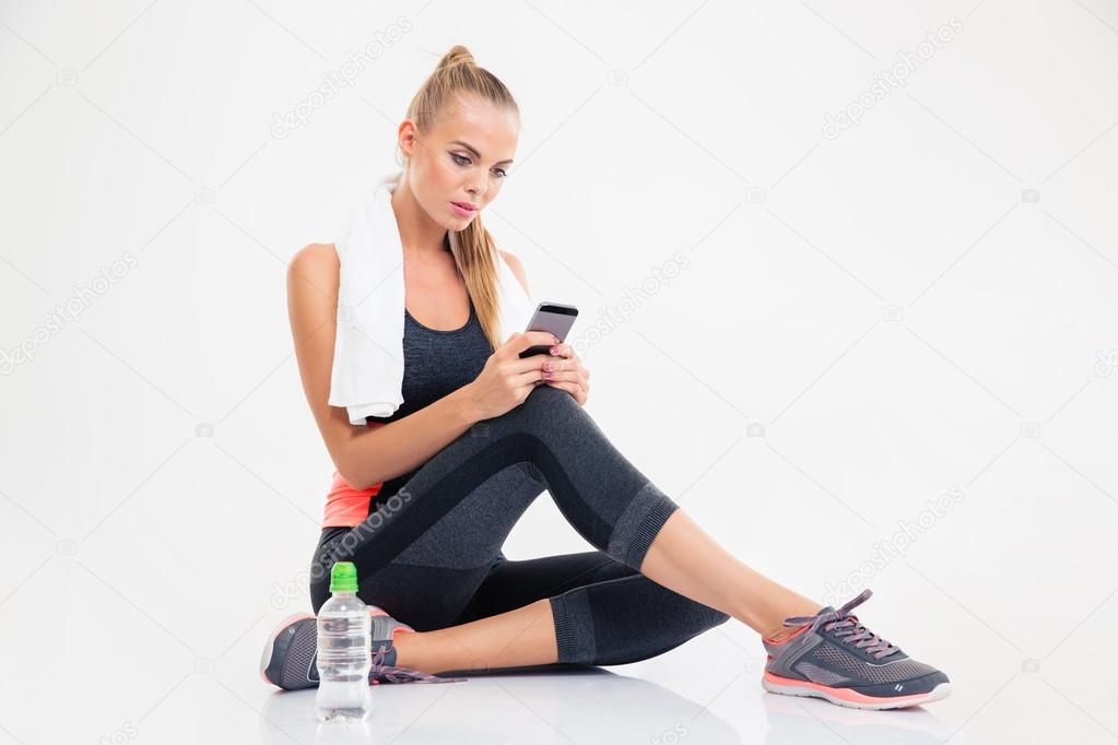 Woman sitting on the floor and using smarpthone