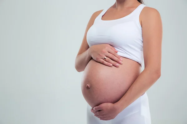 Gravid kvinna smeker magen — Stockfoto