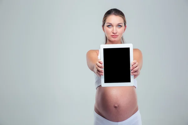 Mujer embarazada mostrando la pantalla del ordenador tableta — Foto de Stock