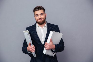 Portrait of a funny businessman holding folders