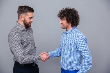 Portrait of a two casual men doing handshake
