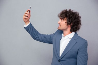 Handsome businessman making selfie photo