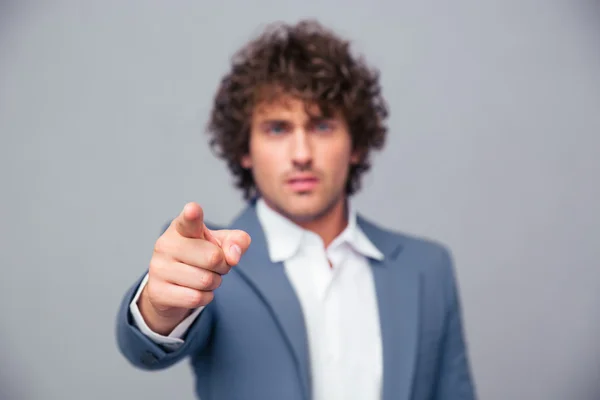 Businessman pointing finger at camera — Stock Photo, Image