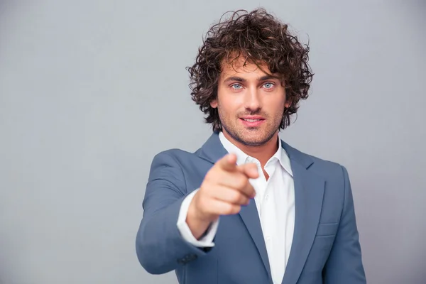 Businessman pointing finger at camera — Stock Photo, Image