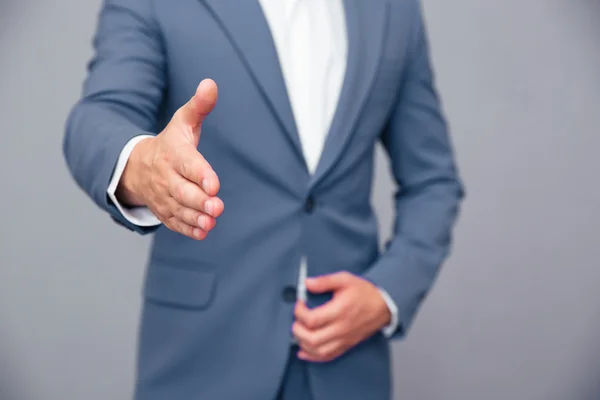 Businessman stretching hand for handshak — Stok fotoğraf