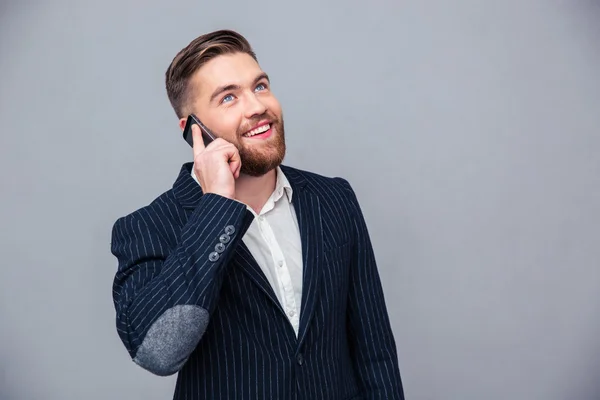 Happy thoughtful businessman talking on the phone — Stock Photo, Image
