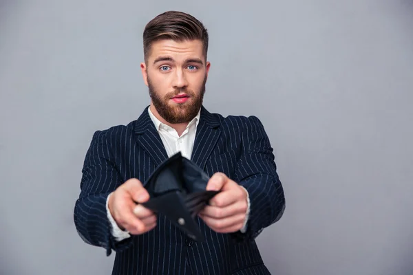 Handsome businessman showing his empty wallet — Stock Photo, Image