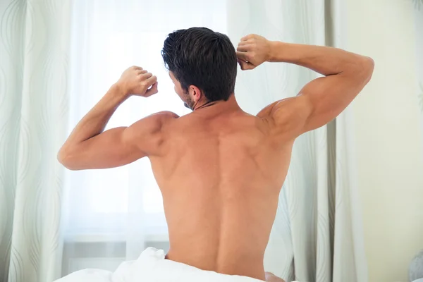Man waking up and stretching hands — Stock Photo, Image