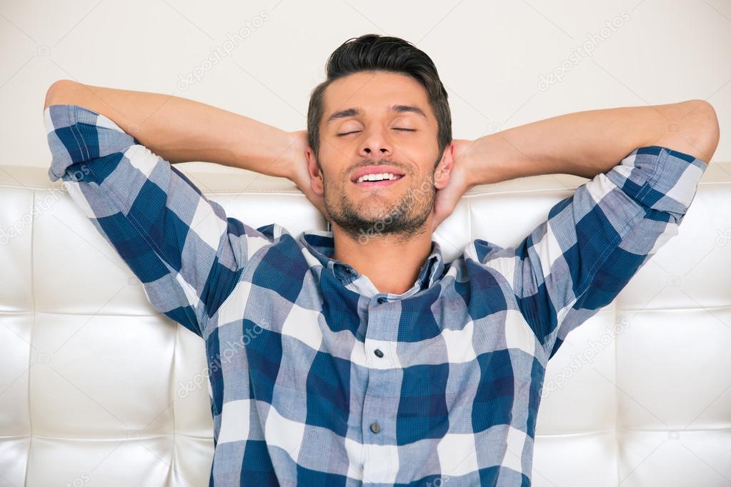 Man resting on the sofa at home