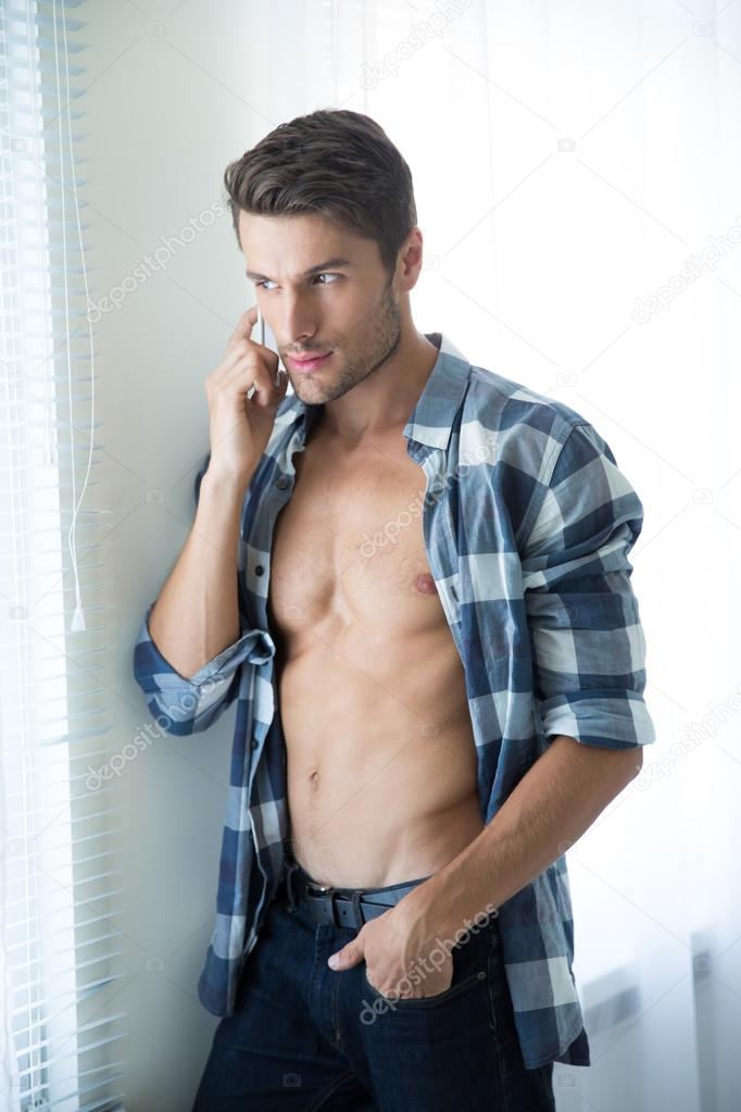 Man talking on the phone and looking in window