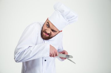 Portrait of a male chef cook sharpening knife i clipart