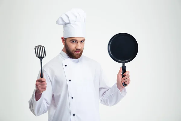 Male chef cook holding pan and spoon — Stock Photo, Image